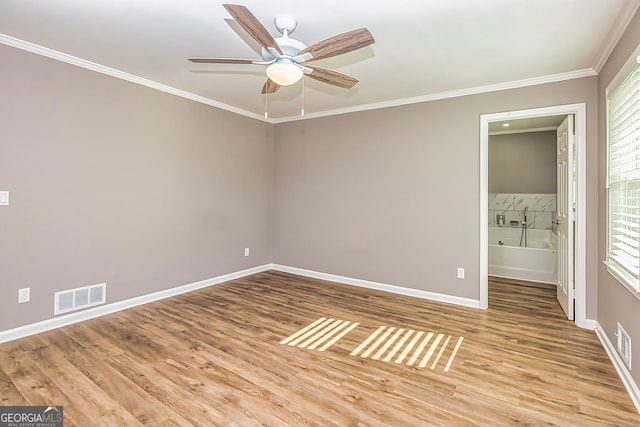 3625 Pointer Rd, Loganville, GA 30052 - empty room featuring a ceiling fan, crown molding, wood finished floors, and baseboards