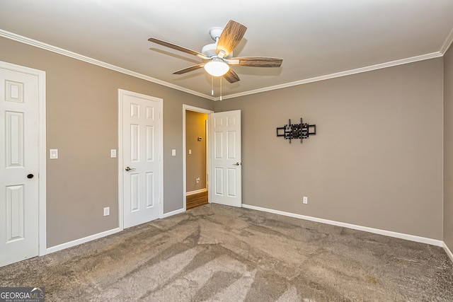 3625 Pointer Rd, Loganville, GA 30052 - unfurnished bedroom with carpet floors, baseboards, ornamental molding, and a ceiling fan