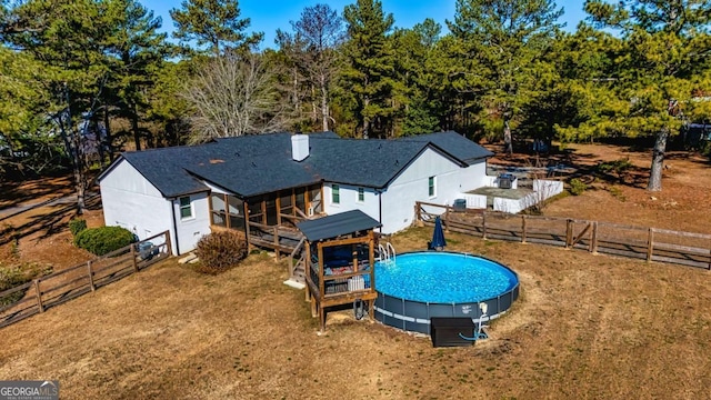 3625 Pointer Rd, Loganville, GA 30052 - back of property with a fenced backyard, a sunroom, and a deck