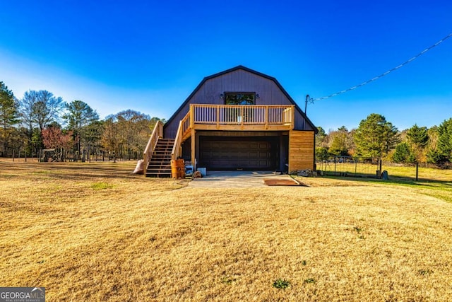 3625 Pointer Rd, Loganville, GA 30052 - view of front facade with a gambrel roof, stairway, a front yard, and a garage