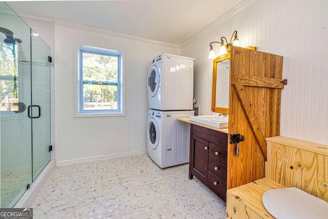 3625 Pointer Rd, Loganville, GA 30052 - full bathroom featuring stacked washer / drying machine, crown molding, a stall shower, vanity, and baseboards