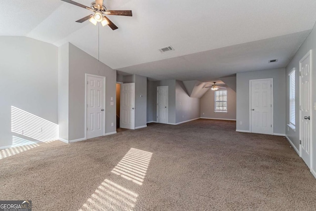 unfurnished living room featuring carpet flooring, ceiling fan, and lofted ceiling