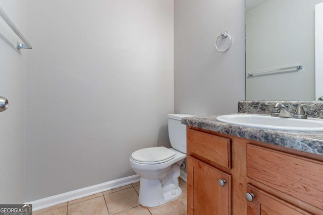 bathroom featuring tile patterned floors, vanity, and toilet