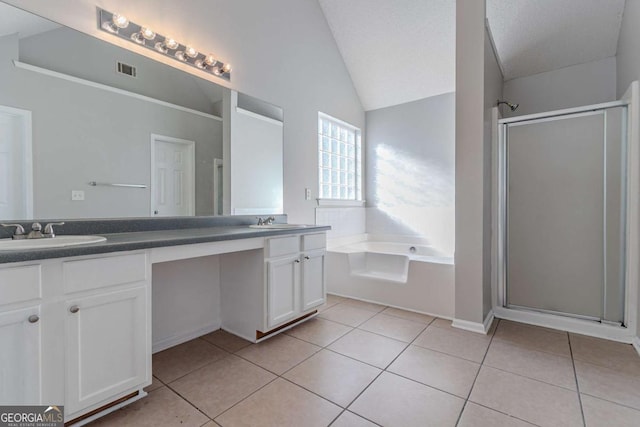 bathroom featuring plus walk in shower, tile patterned floors, a textured ceiling, lofted ceiling, and vanity