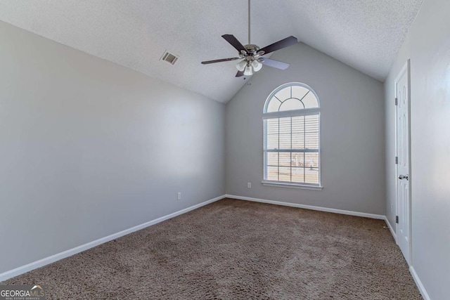 carpeted spare room featuring a textured ceiling, ceiling fan, and lofted ceiling