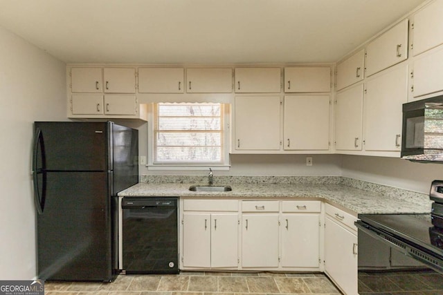 kitchen with white cabinets, sink, and black appliances