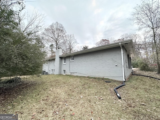 back of house with a lawn