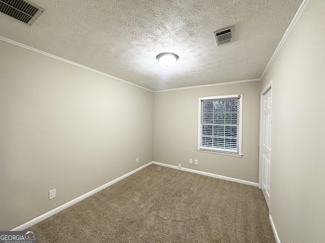 spare room with carpet, a textured ceiling, and crown molding