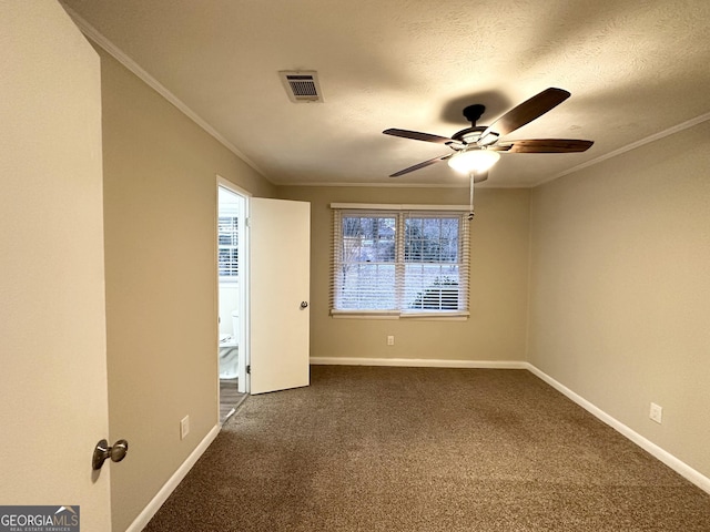 carpeted spare room featuring ceiling fan, crown molding, and a textured ceiling