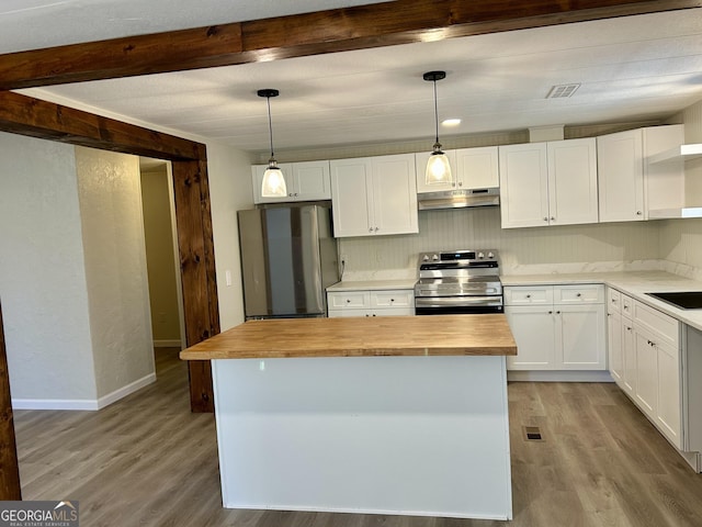 kitchen featuring decorative light fixtures, wooden counters, appliances with stainless steel finishes, white cabinets, and under cabinet range hood