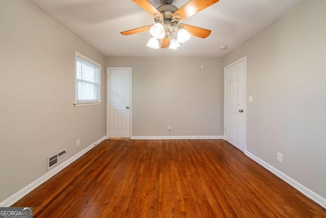 unfurnished room featuring ceiling fan and dark hardwood / wood-style flooring