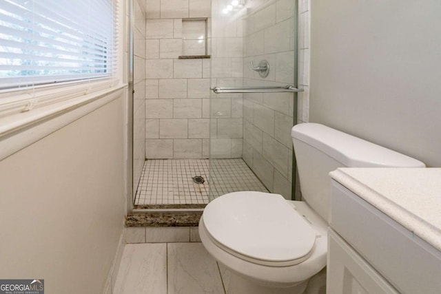 bathroom featuring vanity, toilet, and an enclosed shower