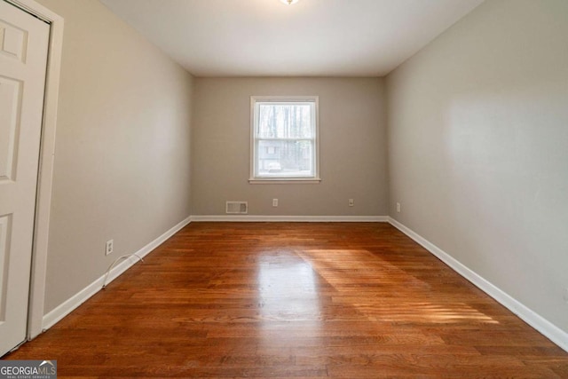 spare room featuring hardwood / wood-style floors