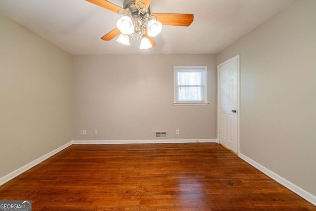 unfurnished room featuring ceiling fan and dark wood-type flooring