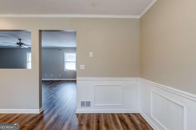 spare room with crown molding, ceiling fan, dark wood-type flooring, and a textured ceiling