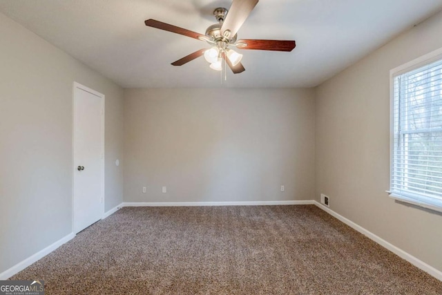 carpeted empty room featuring ceiling fan