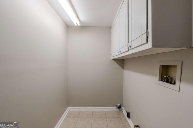 laundry room featuring hookup for a washing machine, light tile patterned floors, and cabinets