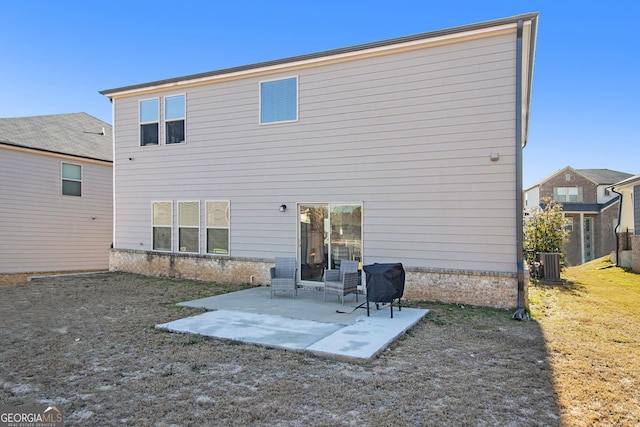 back of house with a yard, a patio, and central air condition unit