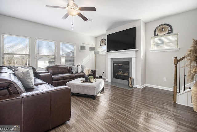 living room with dark hardwood / wood-style floors, ceiling fan, and a healthy amount of sunlight