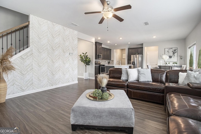 living room with ceiling fan, dark wood-type flooring, and sink