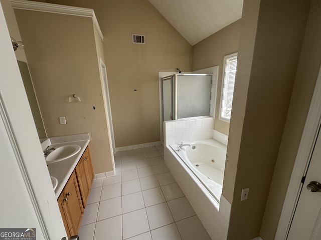 bathroom with tile patterned flooring, vanity, separate shower and tub, and vaulted ceiling