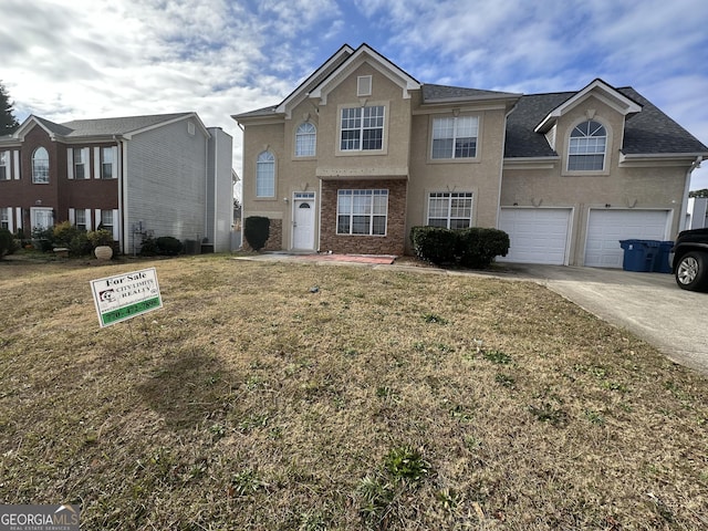 front facade featuring a front yard and a garage