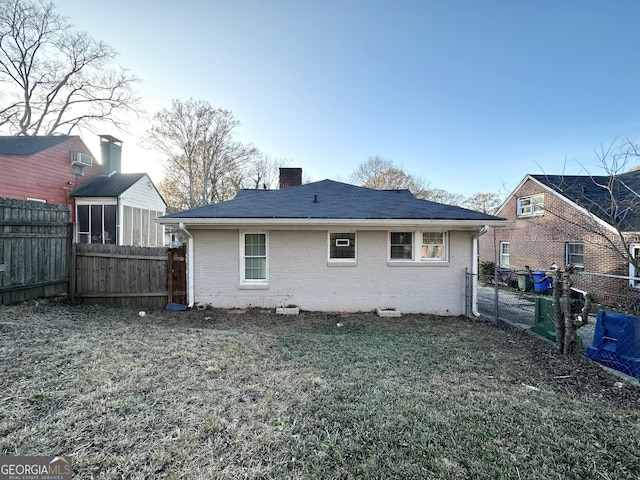 rear view of house with a lawn