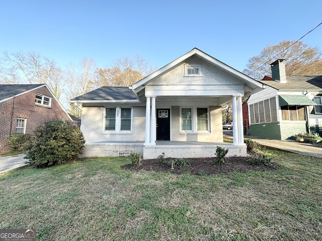 bungalow-style home featuring a porch and a front lawn