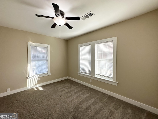 spare room featuring ceiling fan and carpet floors