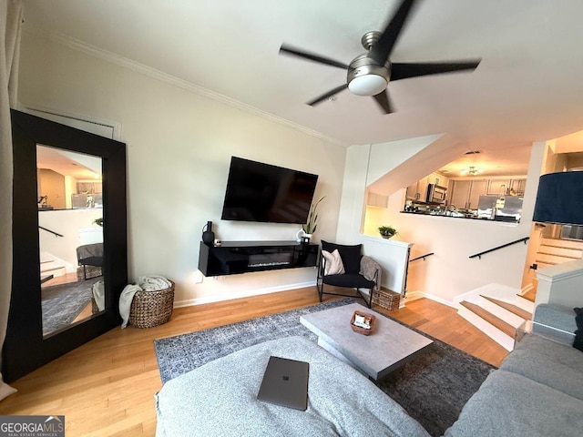 4248 River Green Dr NW Unit 312, Atlanta, GA 30327 - living area featuring a ceiling fan, wood finished floors, crown molding, and baseboards