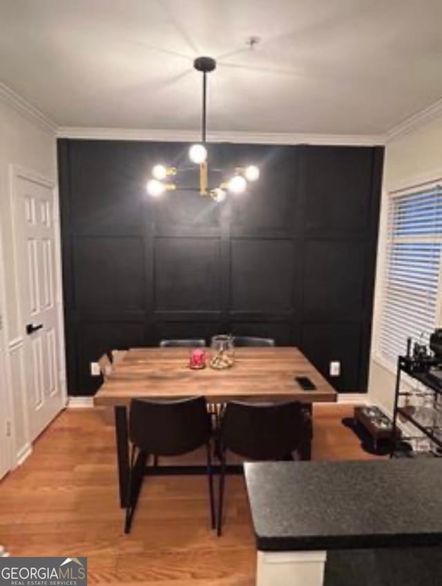 4248 River Green Dr NW Unit 312, Atlanta, GA 30327 - dining room featuring crown molding and light wood-style flooring