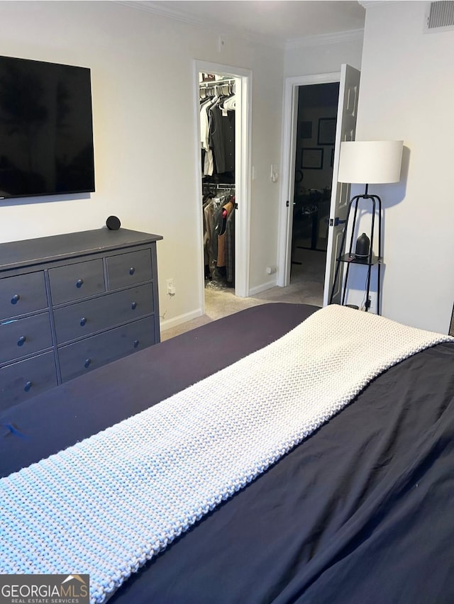 4248 River Green Dr NW Unit 312, Atlanta, GA 30327 - carpeted bedroom featuring a closet, a spacious closet, ornamental molding, and baseboards