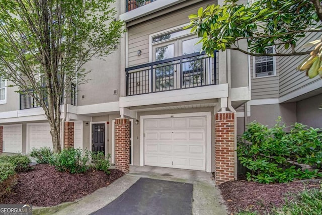 4248 River Green Dr NW Unit 312, Atlanta, GA 30327 - multi unit property featuring stucco siding, an attached garage, asphalt driveway, and brick siding