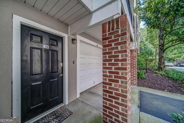 4248 River Green Dr NW Unit 312, Atlanta, GA 30327 - view of exterior entry featuring brick siding and a garage