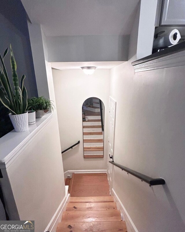 4248 River Green Dr NW Unit 312, Atlanta, GA 30327 - stairway featuring arched walkways, wood finished floors, and baseboards