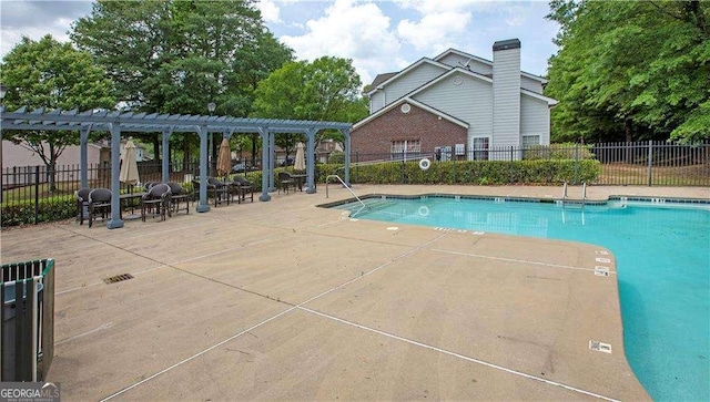 view of swimming pool featuring a pergola and a patio