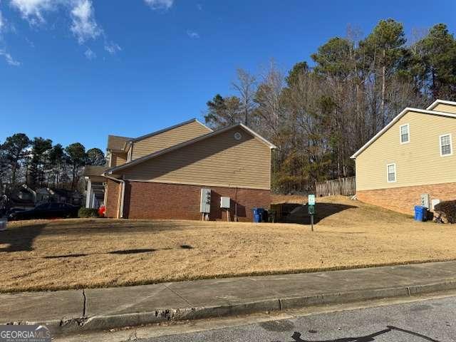 view of side of property with a yard