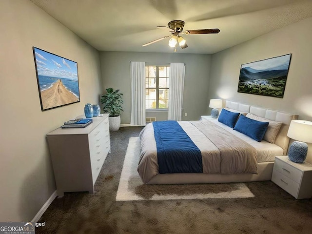 bedroom with dark colored carpet and ceiling fan