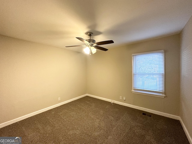 carpeted spare room featuring ceiling fan