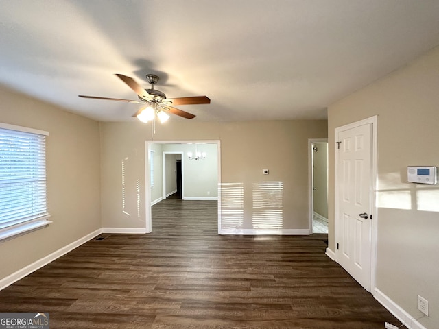 unfurnished room featuring ceiling fan and dark wood-type flooring