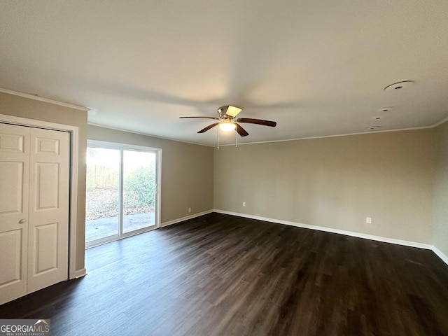 spare room featuring dark hardwood / wood-style floors, ceiling fan, and crown molding