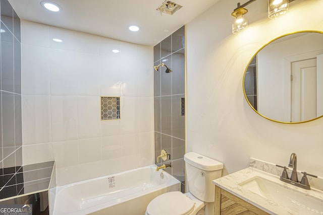 full bathroom featuring vanity, toilet, and tiled shower / bath