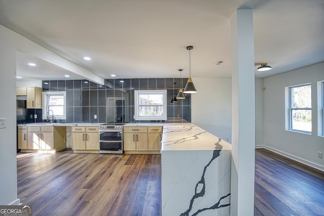 kitchen with tasteful backsplash, light stone counters, decorative light fixtures, stainless steel range with electric stovetop, and light brown cabinetry