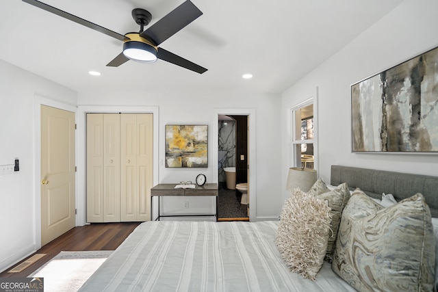 bedroom featuring ceiling fan, dark wood-type flooring, connected bathroom, and a closet