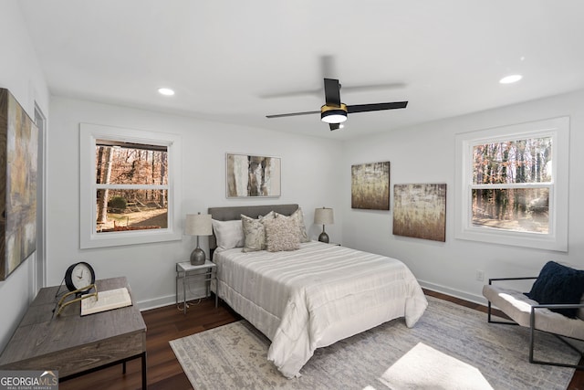 bedroom featuring ceiling fan and dark wood-type flooring