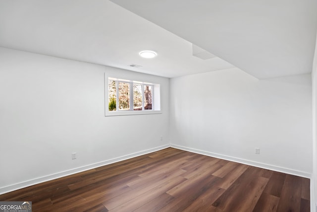 unfurnished room featuring dark hardwood / wood-style flooring