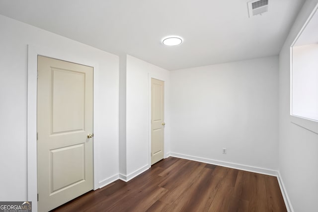 unfurnished bedroom featuring dark wood-type flooring