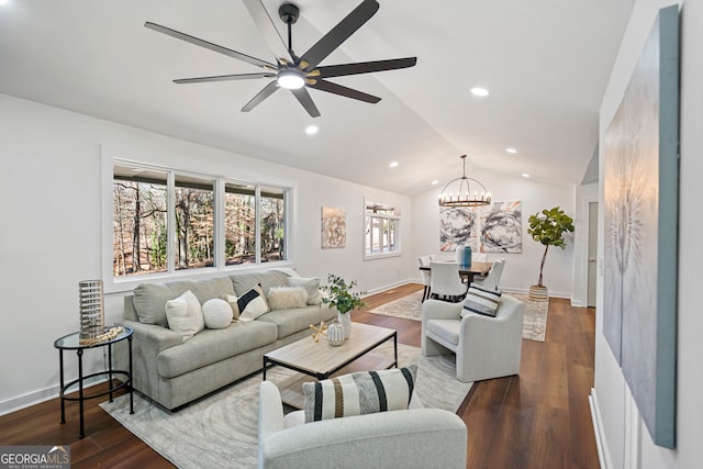 living room featuring ceiling fan with notable chandelier, dark hardwood / wood-style flooring, and lofted ceiling