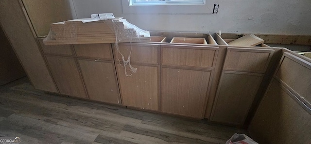 laundry area with light wood-type flooring