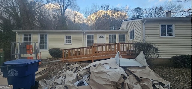 back of property with a wooden deck